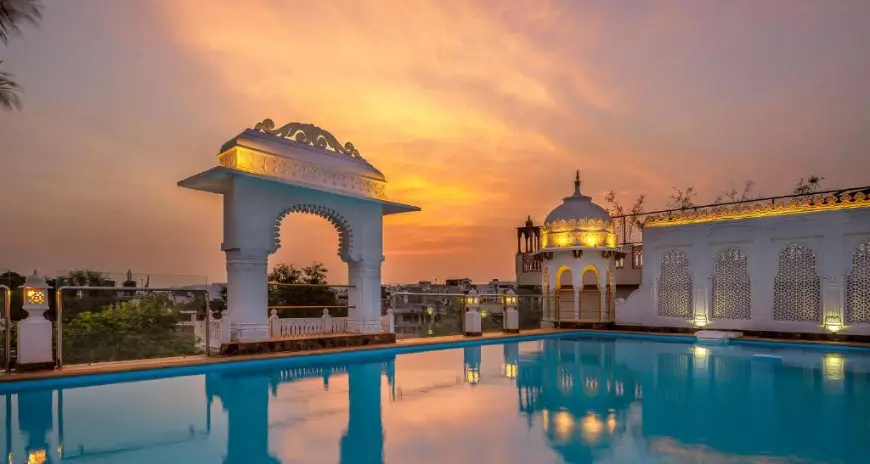 Luxury rooftop pool overlooking a city at sunset