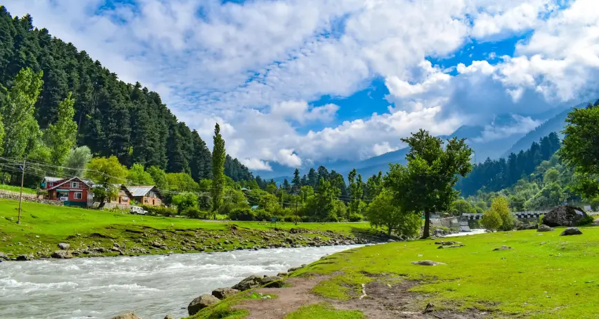 Kashmir valley with river, green meadows and mountains