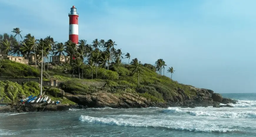 Coastal lighthouse with palm trees and ocean waves